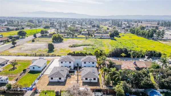 an aerial view of residential houses with outdoor space and swimming pool
