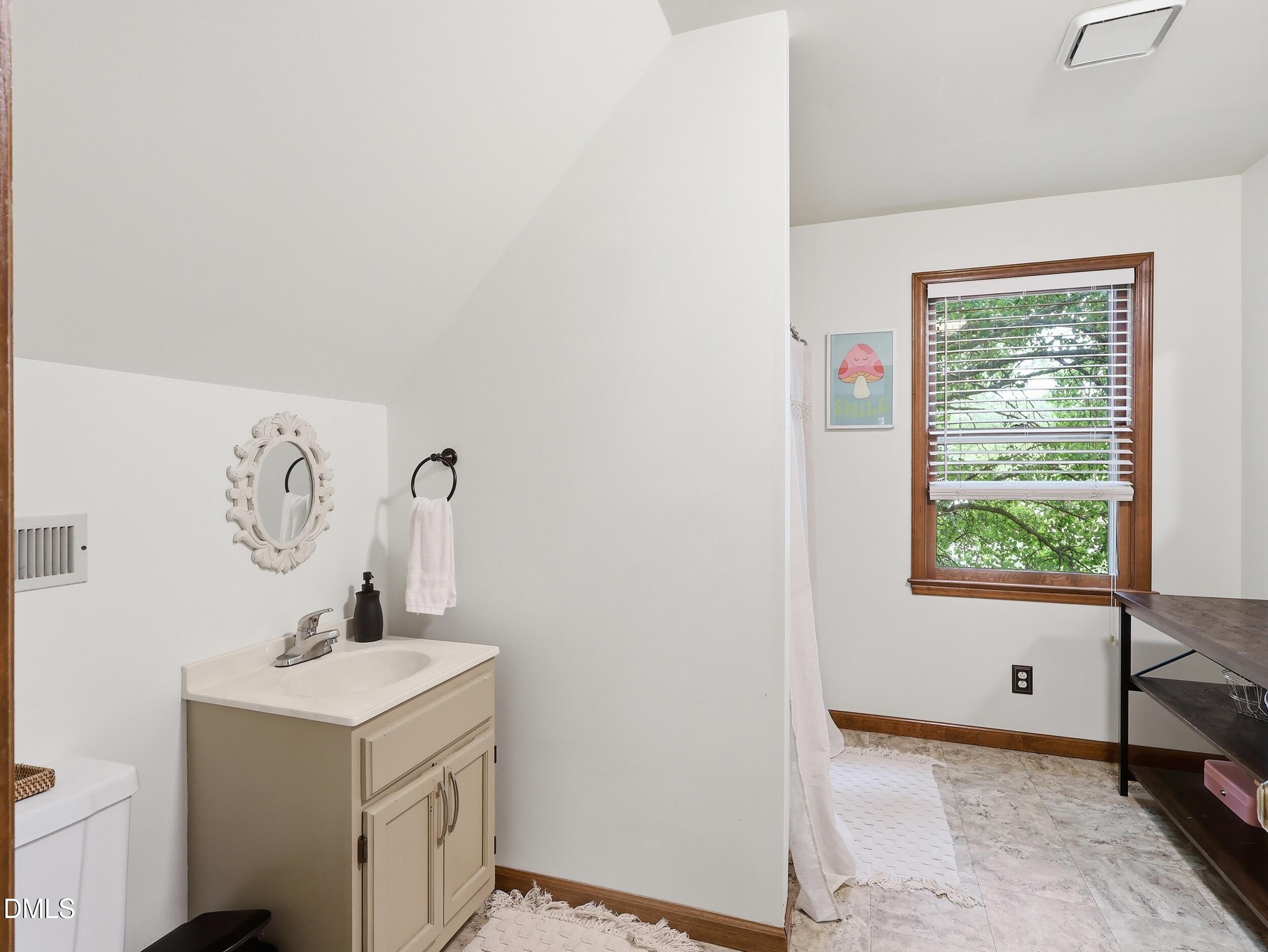 517 Lake Glad Road Wendell, NC 27591 - Photo 22 of 36 a view of bathroom with a window and a sink