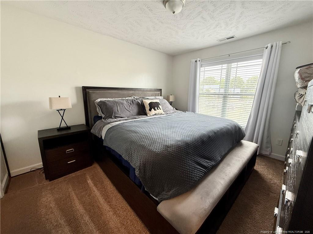 35 Ambrose Point Cameron, NC 28326 - Photo 15 of 31 a bedroom with a bed and window