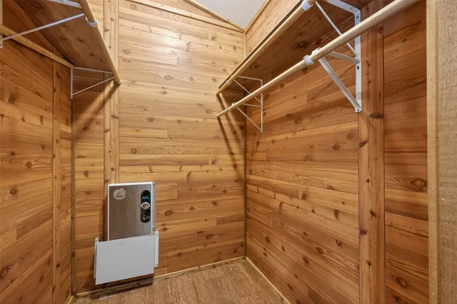 a view of a room with wooden floor and cabinet