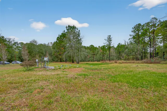 a house with green field in front of it