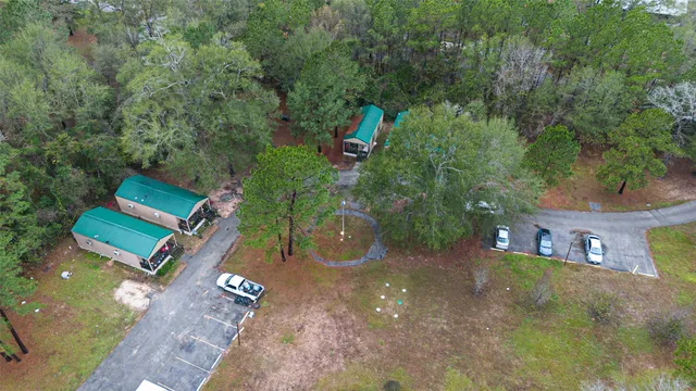an aerial view of a house with a yard