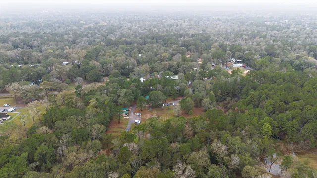 an aerial view of house with yard and mountain view in back