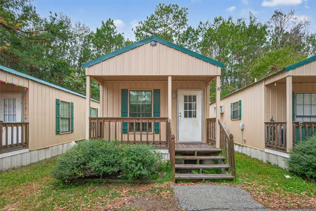a view of a house with a yard and deck