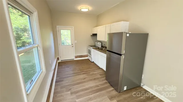 a view of a kitchen from the hallway