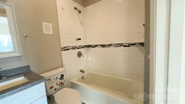 a bathroom with a shower toilet and bathtub