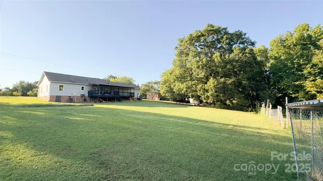 a car parked in front of a house with a big yard
