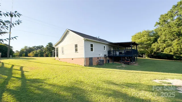 a view of a house with pool and a yard