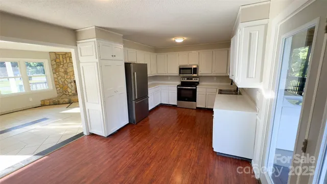a kitchen with a refrigerator and a stove top oven