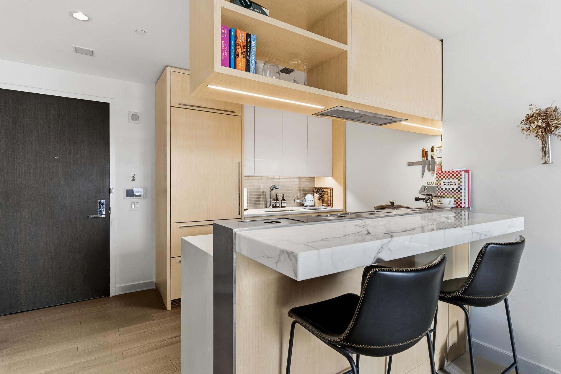 252 South Street, Unit 18B Manhattan, NY 10002 - Photo 2 of 12 a dining table with chairs and wooden floor