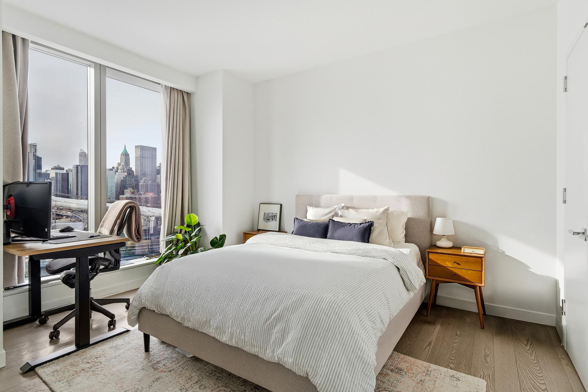 252 South Street, Unit 18B Manhattan, NY 10002 - Photo 6 of 12 a bedroom with a bed a large window and chair