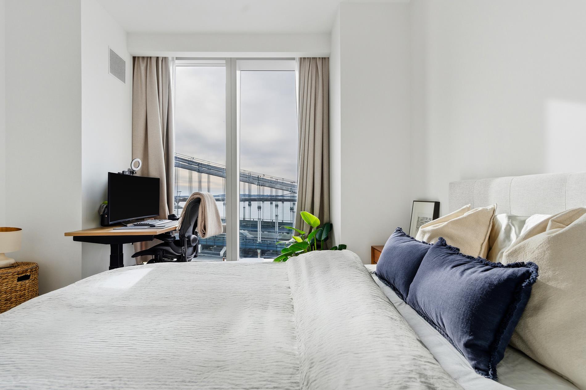 252 South Street, Unit 18B Manhattan, NY 10002 - Photo 7 of 12 a bedroom with a bed and a potted plant