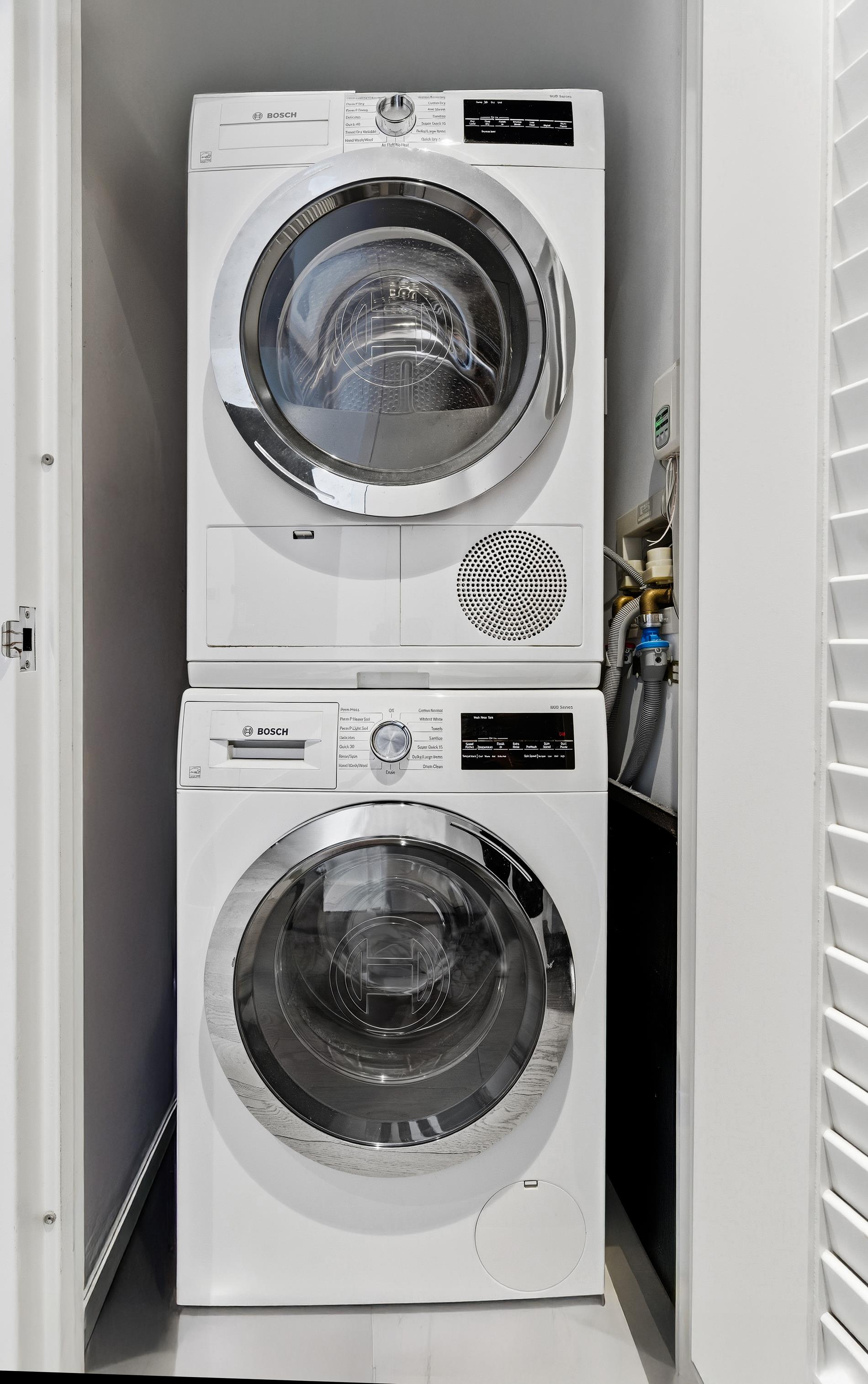 252 South Street, Unit 18B Manhattan, NY 10002 - Photo 9 of 12 a utility room with dryer and washer