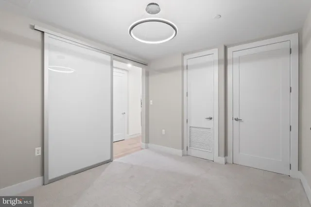 a view of a hallway with washer and dryer