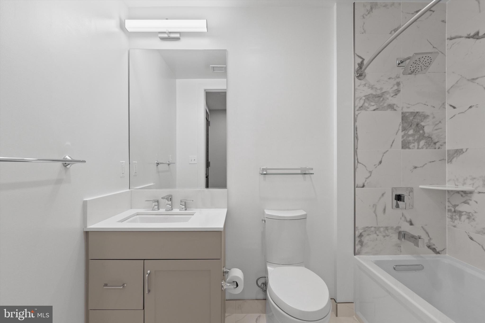 801 North Fairfax Street, Unit 318 Alexandria, VA 22314 - Photo 14 of 26 a bathroom with a sink toilet and shower