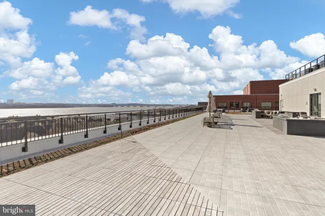 a living room with furniture kitchen view and a flat screen tv
