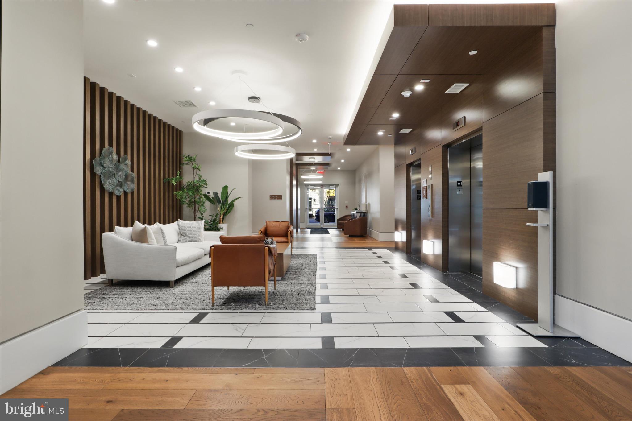 801 North Fairfax Street, Unit 318 Alexandria, VA 22314 - Photo 21 of 26 a living room with furniture and a wooden floor