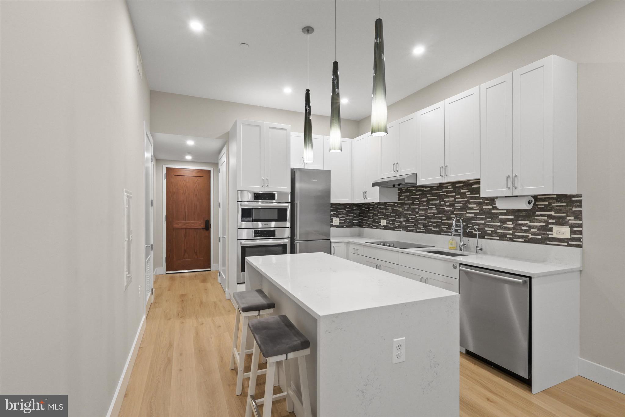 801 North Fairfax Street, Unit 318 Alexandria, VA 22314 - Photo 3 of 26 a large kitchen with a large counter top appliances and cabinets