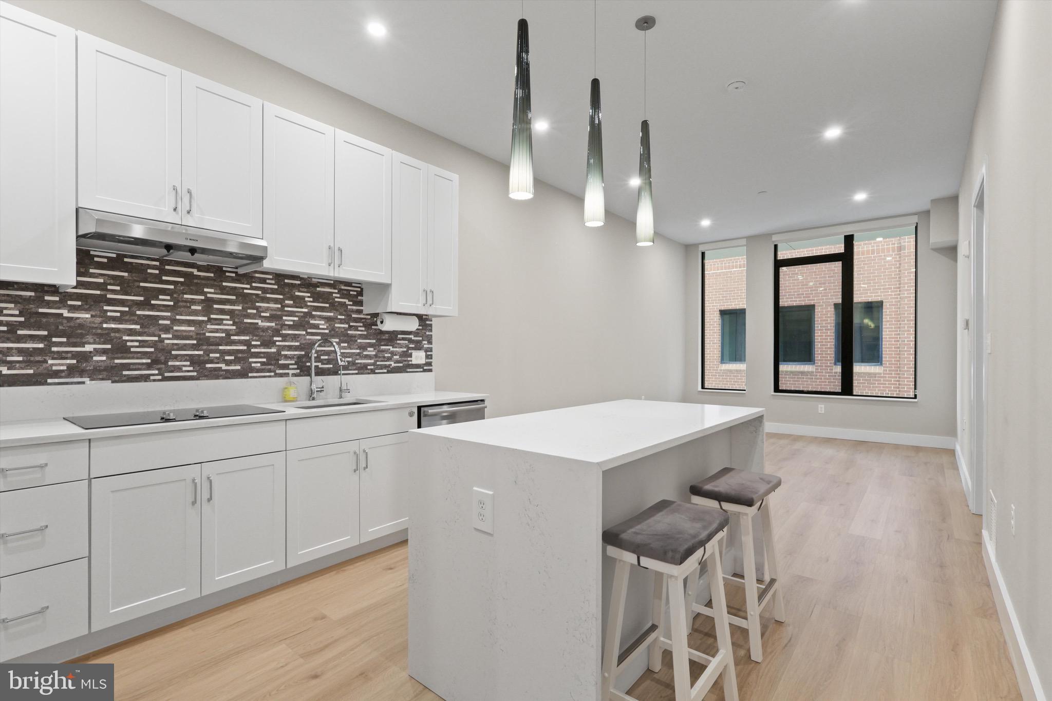 801 North Fairfax Street, Unit 318 Alexandria, VA 22314 - Photo 4 of 26 a kitchen that has a sink and a stove in it