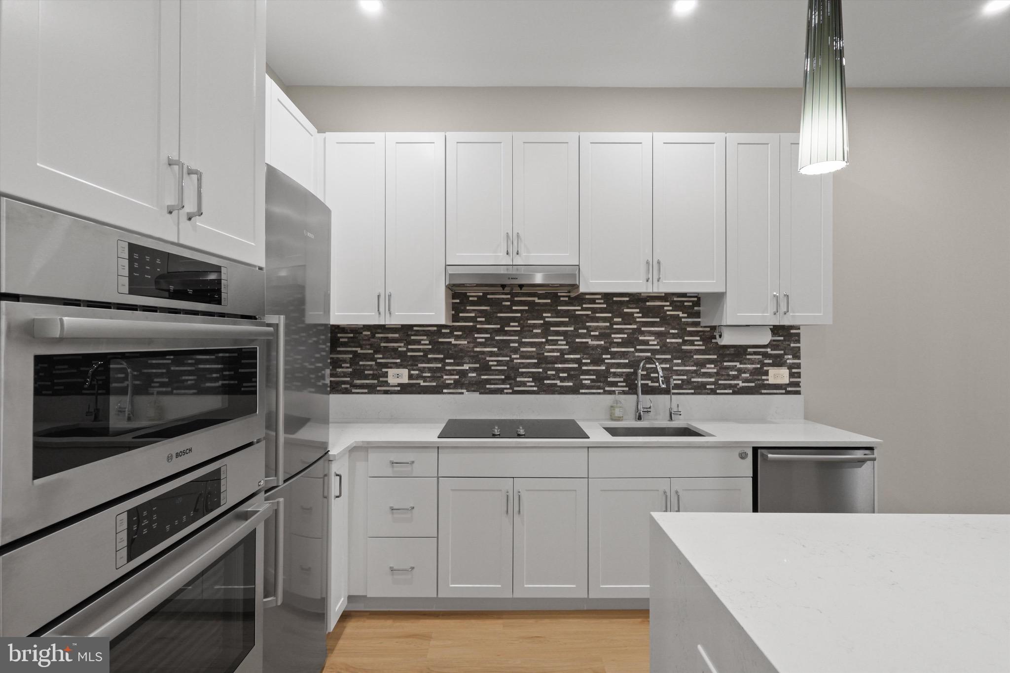 801 North Fairfax Street, Unit 318 Alexandria, VA 22314 - Photo 5 of 26 a kitchen with white cabinets and appliances