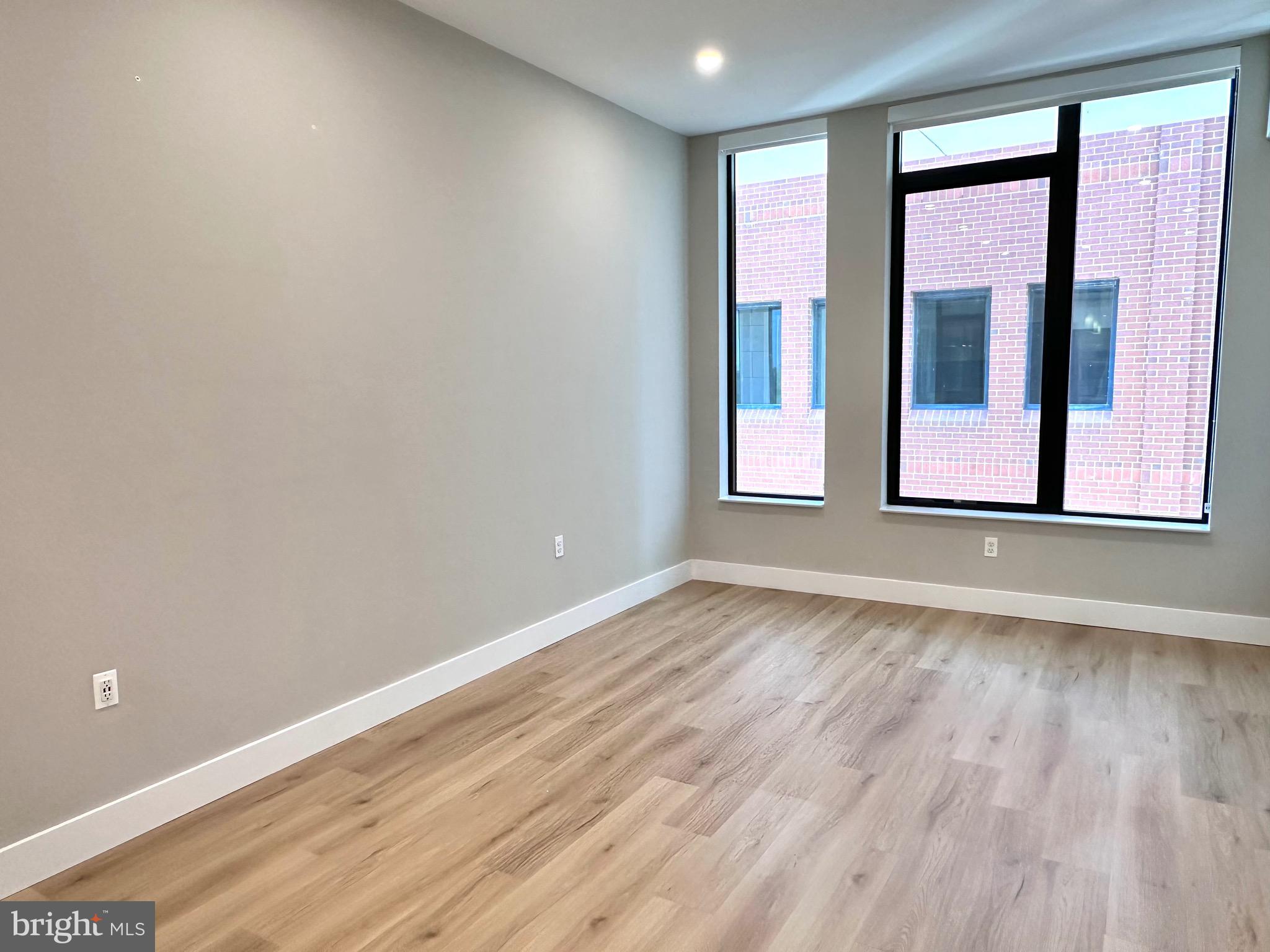 801 North Fairfax Street, Unit 318 Alexandria, VA 22314 - Photo 6 of 26 a view of an empty room with wooden floor and a window