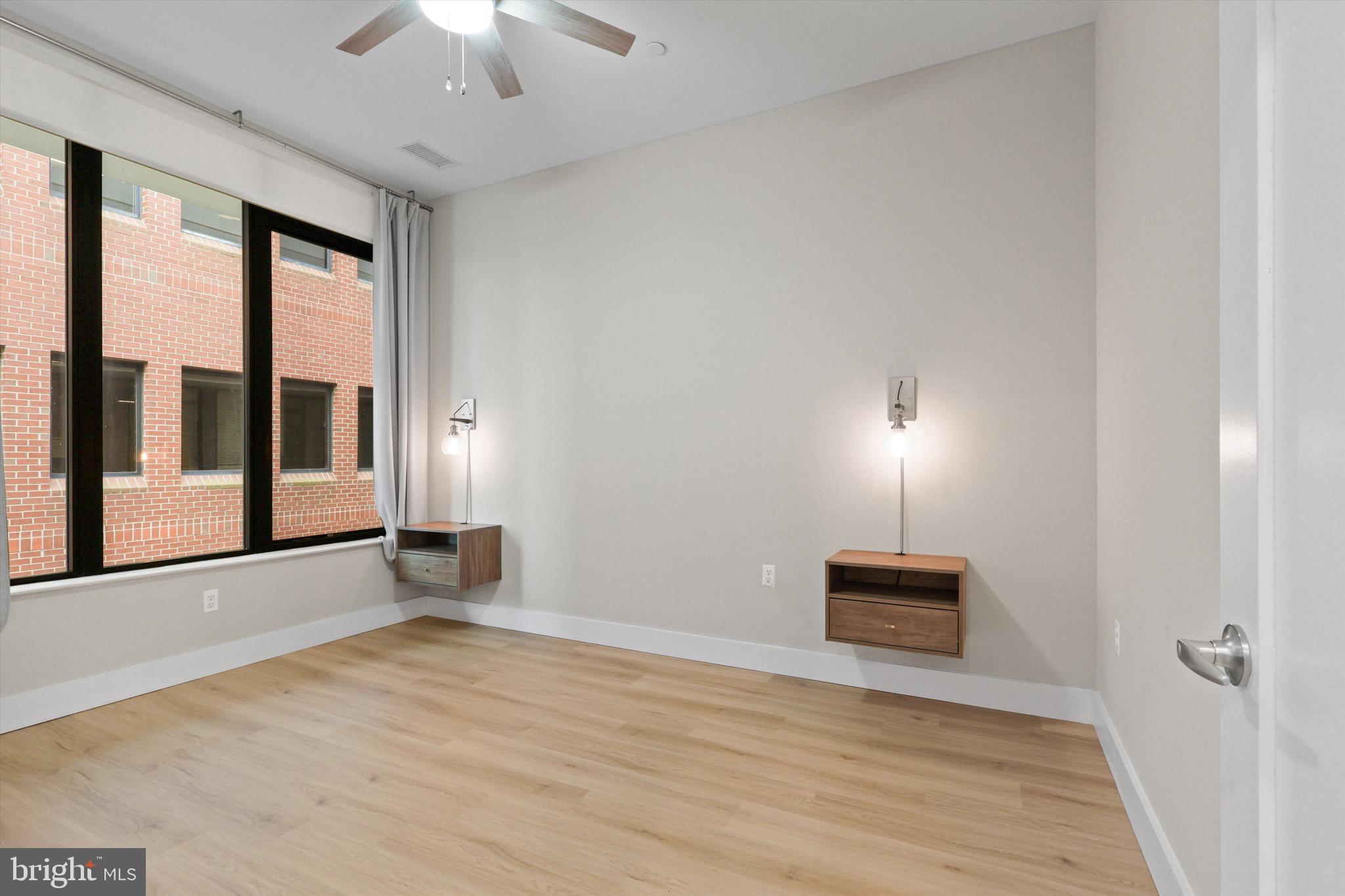 801 North Fairfax Street, Unit 318 Alexandria, VA 22314 - Photo 8 of 26 a view of a livingroom with wooden floor and a ceiling fan