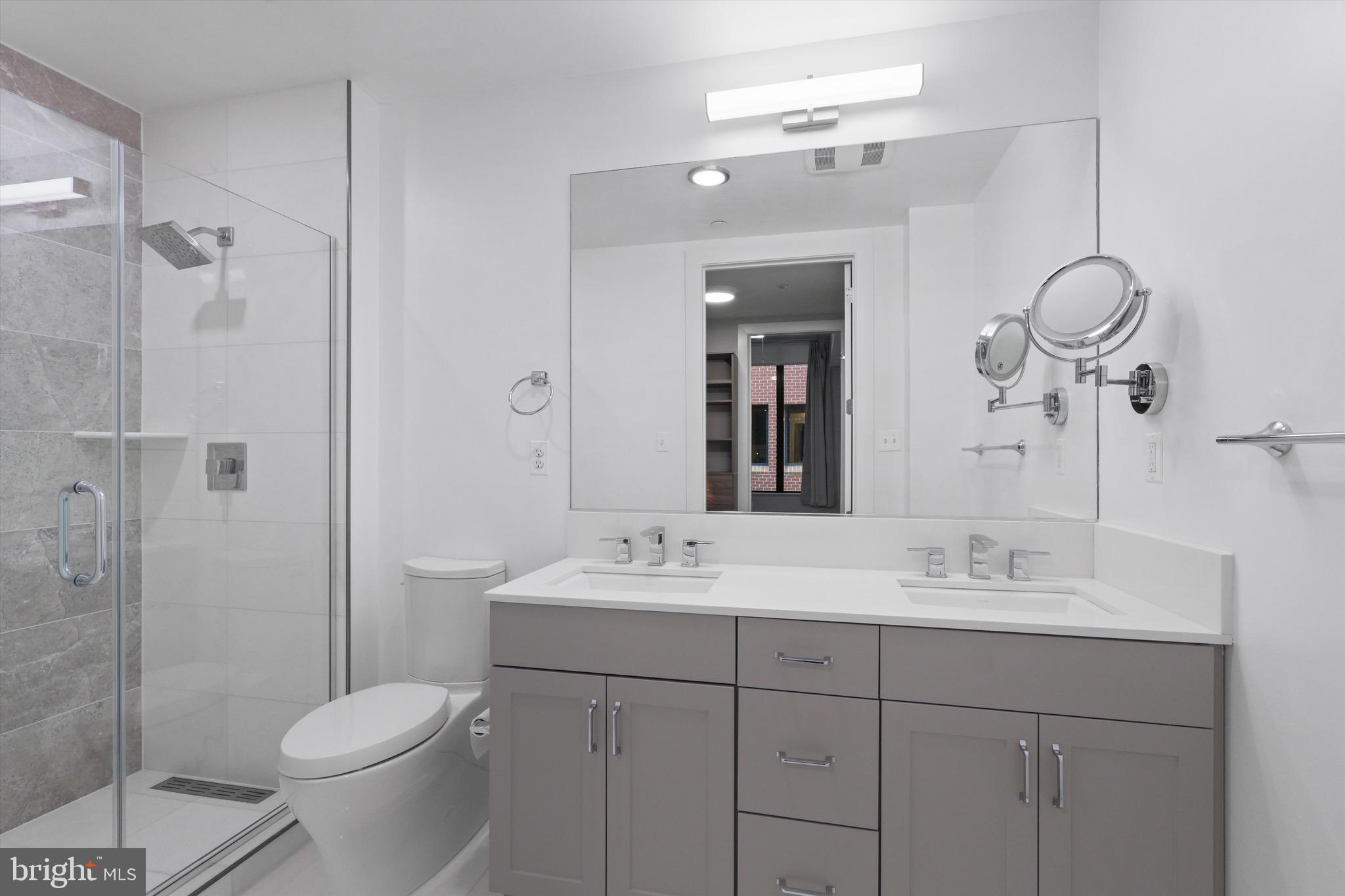 801 North Fairfax Street, Unit 318 Alexandria, VA 22314 - Photo 9 of 26 a bathroom with a sink toilet and shower