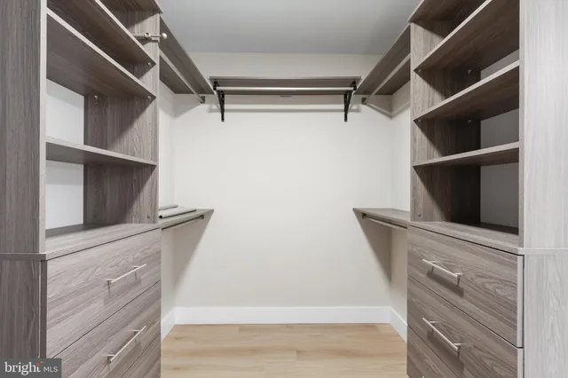 a view of walk in closet and bedroom view