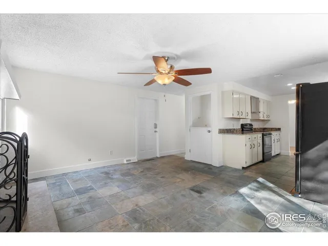 a view of kitchen with cabinets microwave and refrigerator