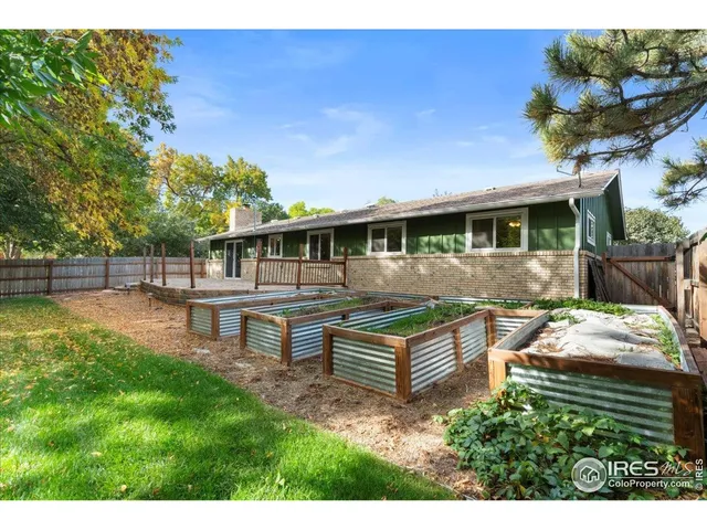 a view of a house with backyard wooden floor and sitting area
