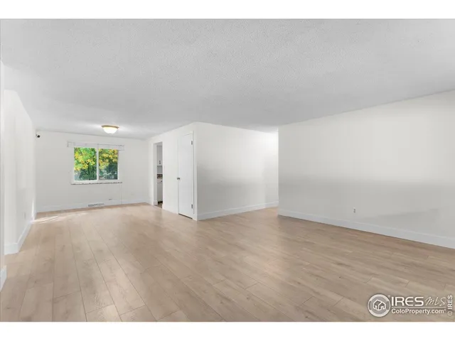 a view of an empty room and a window