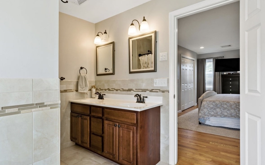 357 Ludlow Street Fall River, MA 02721 - Photo 13 of 19 a en suite bathroom with a double vanity sink and a mirror