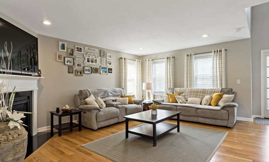357 Ludlow Street Fall River, MA 02721 - Photo 3 of 19 a living room with furniture a flat screen tv and a fireplace