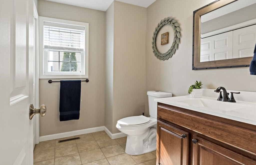 357 Ludlow Street Fall River, MA 02721 - Photo 8 of 19 a bathroom with a sink a toilet and a mirror