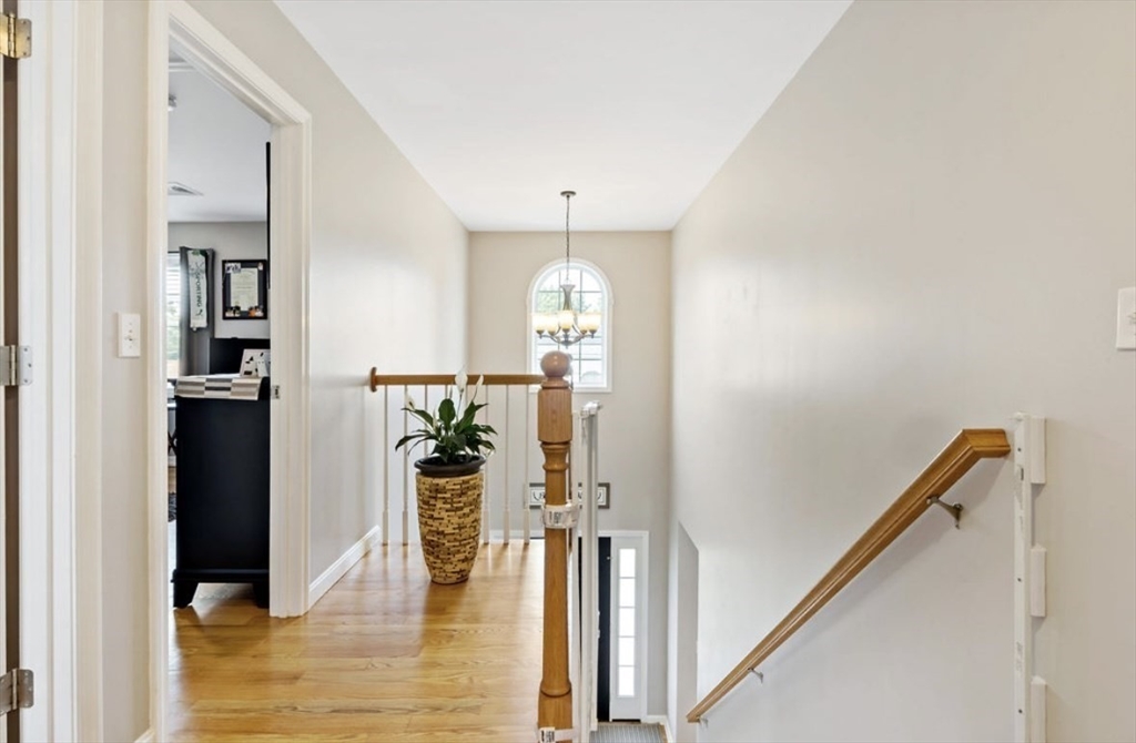 357 Ludlow Street Fall River, MA 02721 - Photo 9 of 19 a view of a hallway with wooden floor and staircase