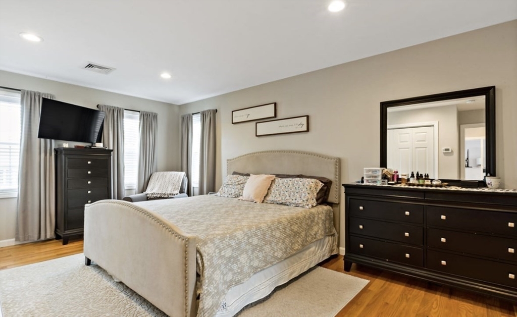357 Ludlow Street Fall River, MA 02721 - Photo 10 of 19 a bedroom with a bed and a flat screen tv