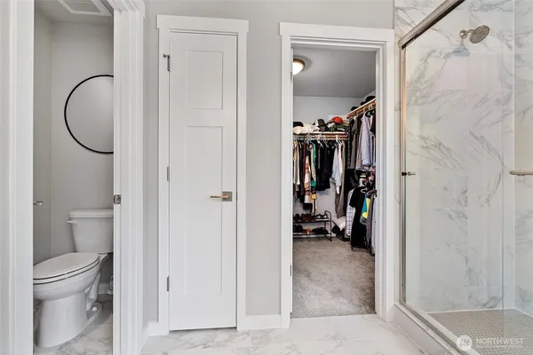 a view of a walk in closet and bathroom