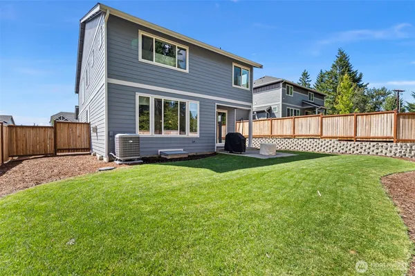 a view of a house with a yard and a garden