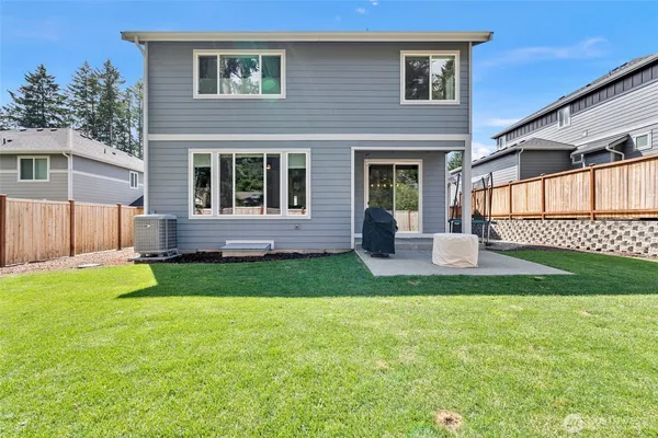 a view of a house with a yard and a garden