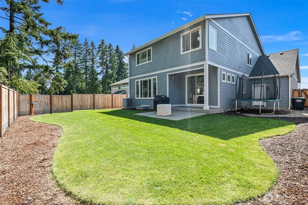 a view of a house with a backyard