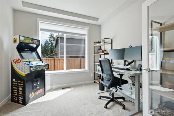 a view of a workspace with furniture and a window