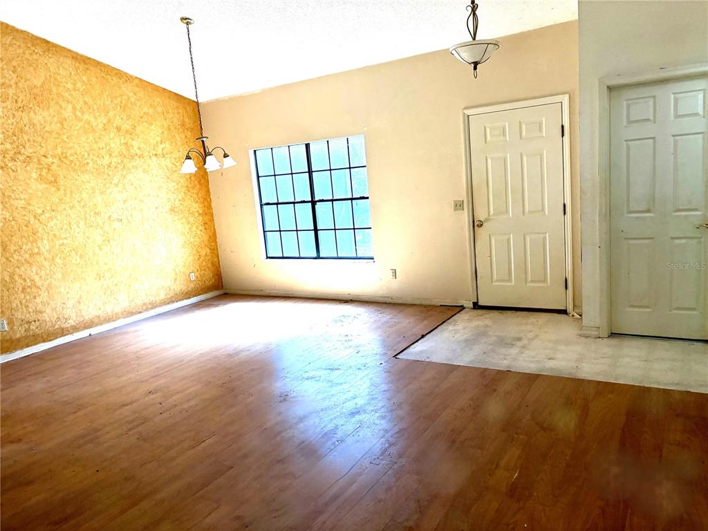 795 Scooter Point Geneva, FL 32732 - Photo 4 of 12 an empty room with wooden floor and windows