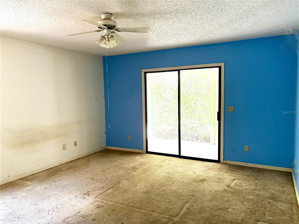 795 Scooter Point Geneva, FL 32732 - Photo 8 of 12 an empty room with windows and fan
