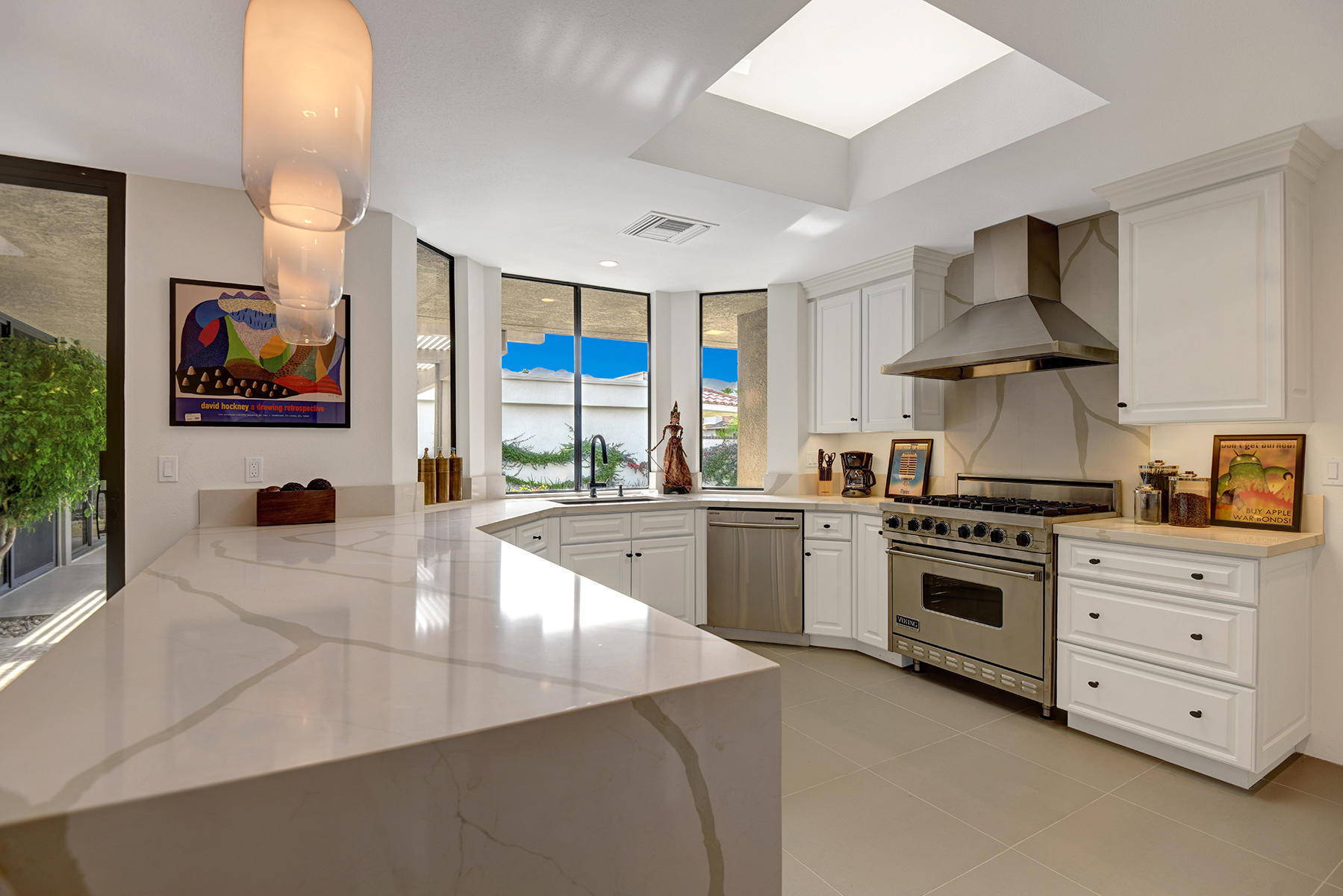 21 Colgate Drive Rancho Mirage, CA 92270 - Photo 14 of 38 a kitchen with stainless steel appliances granite countertop a stove and a sink