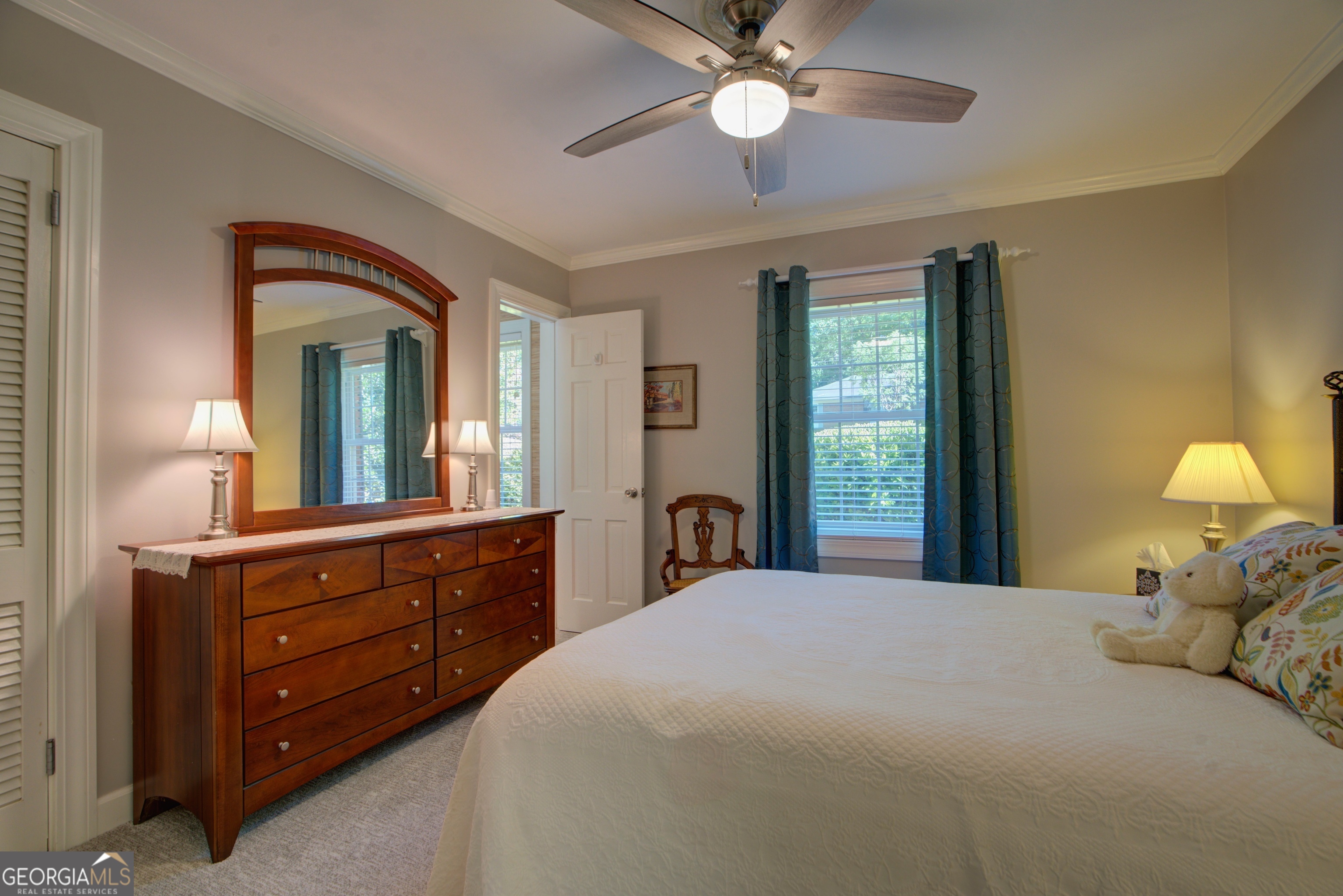 204 Green View Road Southwest Rome, GA 30165 - Photo 46 of 62 a bedroom with a large bed and a chandelier