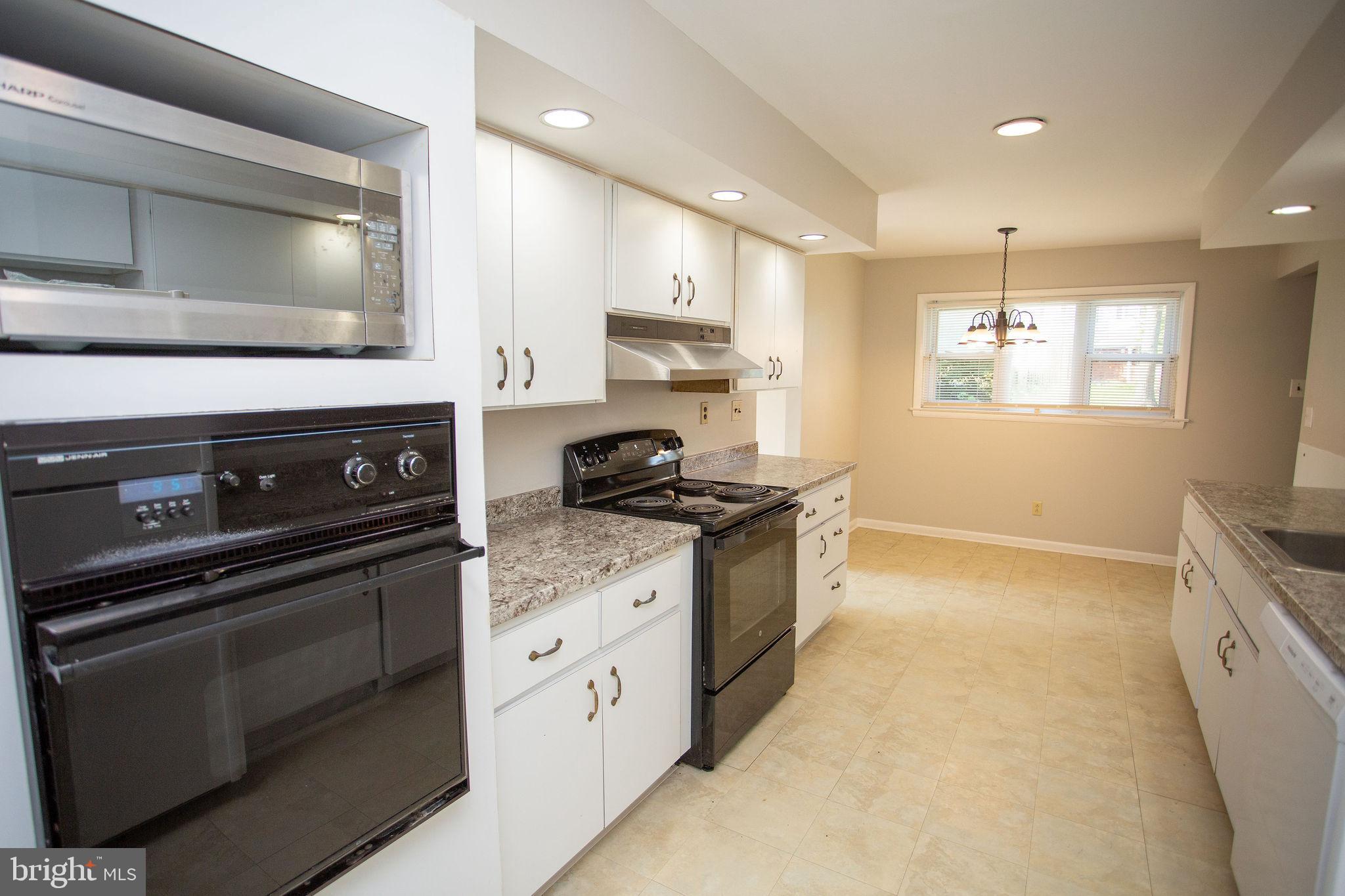 1016 Eagle Lane Cherry Hill, NJ 08003 - Photo 11 of 54 a kitchen with stainless steel appliances granite countertop a stove a sink and a microwave