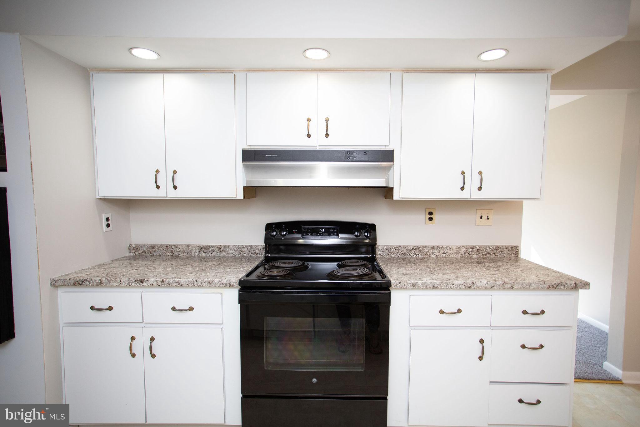1016 Eagle Lane Cherry Hill, NJ 08003 - Photo 13 of 54 a kitchen with granite countertop white cabinets and stainless steel appliances