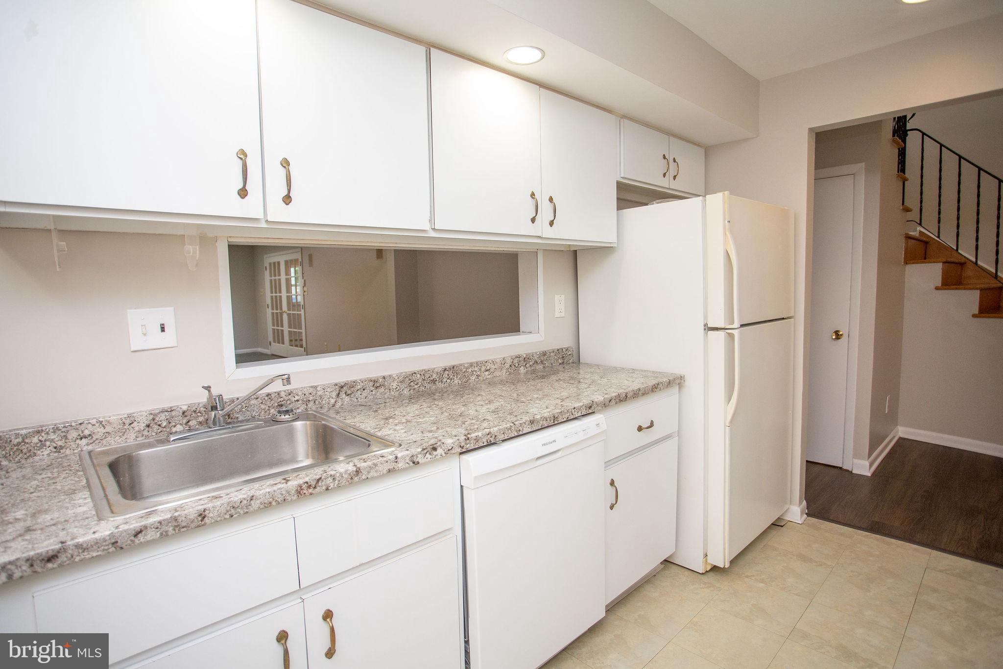 1016 Eagle Lane Cherry Hill, NJ 08003 - Photo 15 of 54 a kitchen with granite countertop a sink a refrigerator a stove and white cabinets