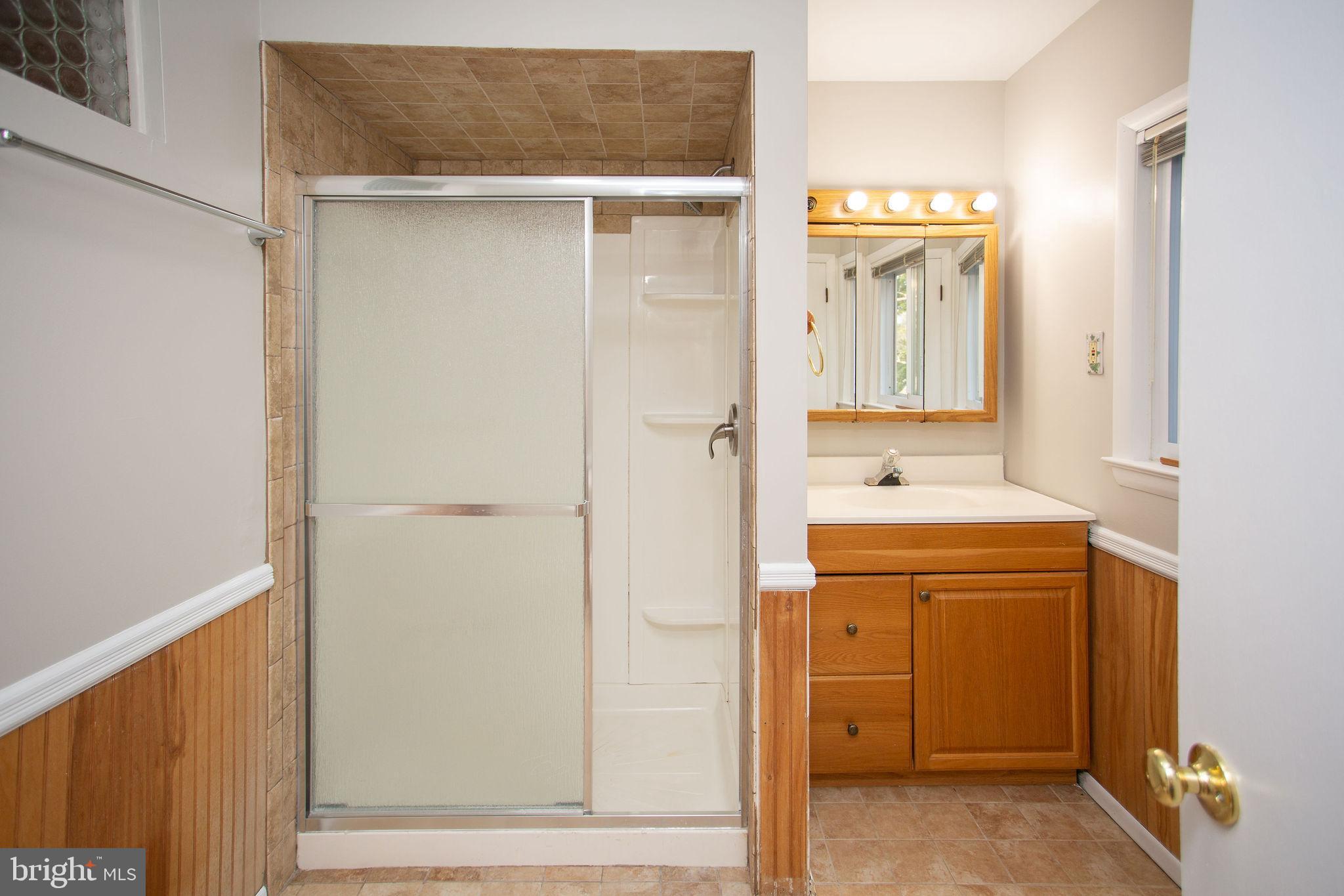 1016 Eagle Lane Cherry Hill, NJ 08003 - Photo 37 of 54 a bathroom with a sink a mirror and a shower