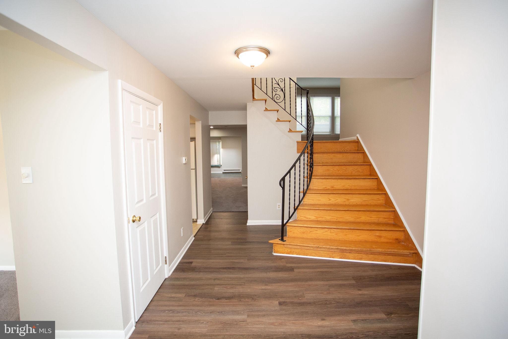 1016 Eagle Lane Cherry Hill, NJ 08003 - Photo 5 of 54 a view of a hallway with wooden floor and stairs